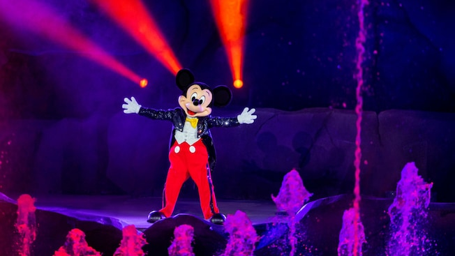 Mickey Mouse standing in front of lasers and water fountains in Fantasmic! at Hollywood Studios