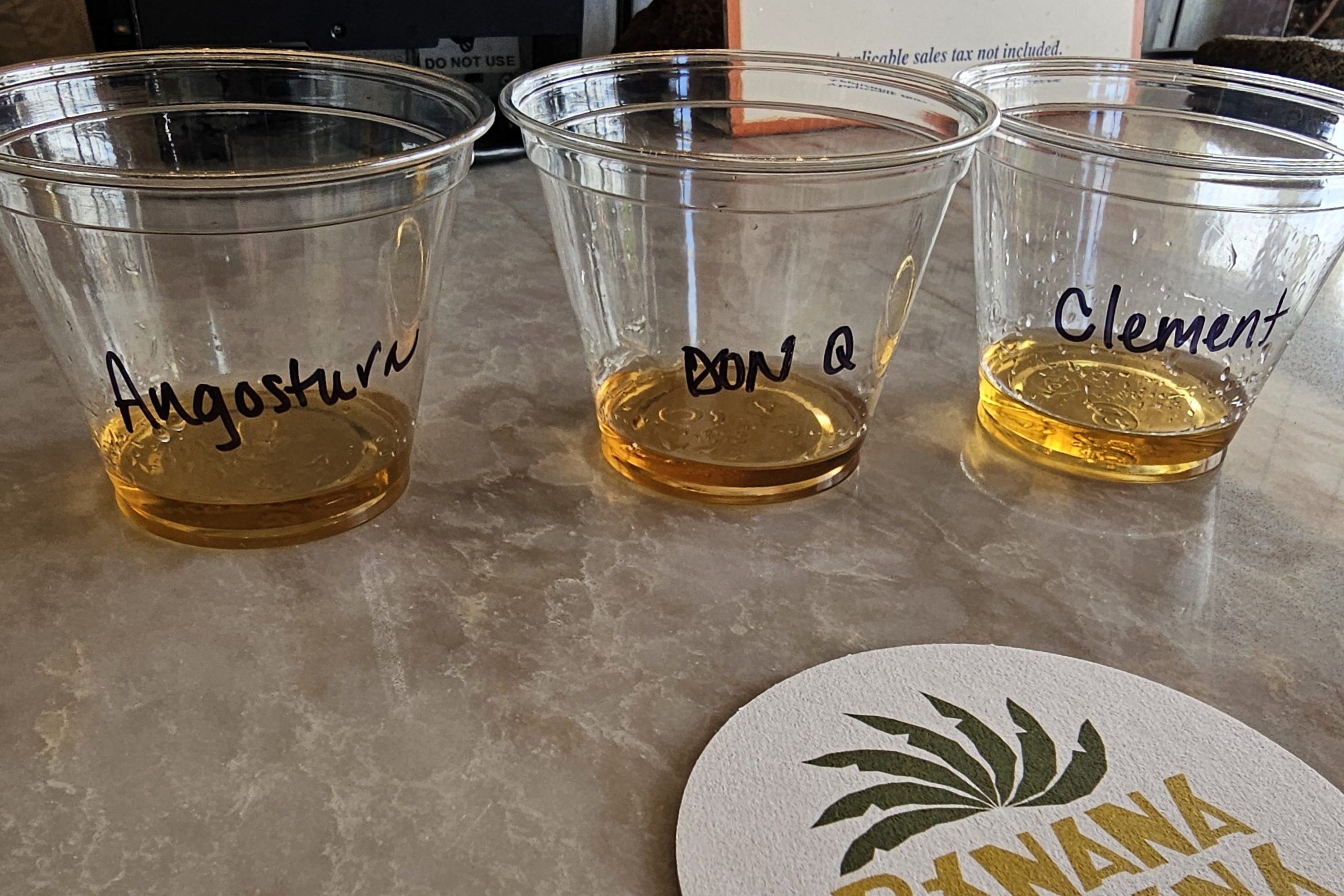 Three plastic cups with rum from Banana Cabana at Disney's Caribbean Beach Resort